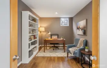 Virtually staged den sits behind frosted glass French doors off the living room. It’s large enough for a huge office or a guest room. Add a Murphy bed for flexibility if you’d like.