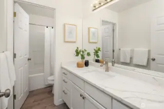 The guest bath on the upper floor with updated counters.