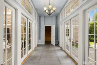 Atrium just off the family room that leads to the garage, a 2nd elevator and the guest house.