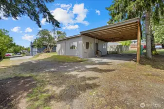 Behind the main house is this cottage with a carport