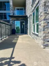 Primary bedroom has a slider that opens to the patio!  This is the side patio that also shows a portion of your privacy fence on the left.