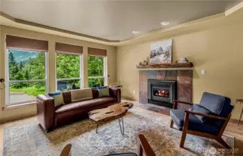 A wall of windows frames mountain views while the fireplace sets the mood - invites slow mornings, relaxed evenings, and quiet moments surrounded by handcrafted charm.