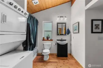 This well-appointed bath and laundry combo makes the apartment above the garage fully self-sufficient - offering convenience, comfort, and rustic charm all in one beautifully designed space.