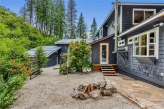 Tucked between the trees and under wide mountain skies, this firepit courtyard is the perfect spot to gather, unwind, and swap stories - just steps from the home, garden, and guest quarters beyond.