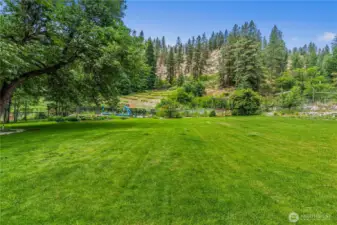 Room to roam, play, and dream, this wide-open lawn invites picnics under the trees, summer games in the sun, and quiet evenings watching the hills turn golden in the distance.