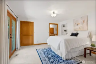 Primary bedroom w/French doors to back deck and yard