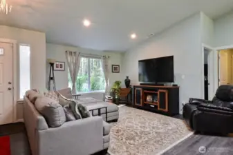 Vaulted ceilings and sky lights are just a few reasons to love this room. Doors and hallway on right are the den and laundry room with access to the attached garage.