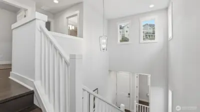 This open stairwell brings in beautiful natural light, enhancing the home’s modern feel.