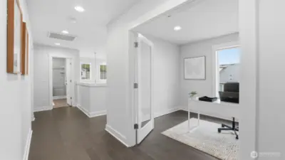 This spacious upper hallway offers great flow with a light-filled office right off the landing.