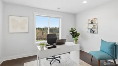 Beautifully appointed flex room, staged as a serene and functional home office