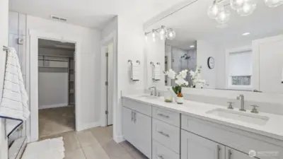 Enjoy a bright and beautifully finished primary bath with double sinks and ample storage
