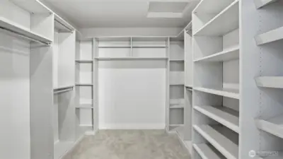 Expansive primary walk-in closet with custom built-ins and abundant storage.