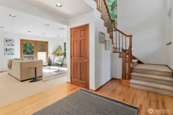 The lofty foyer is flooded with natural light and rich wood flooring and finishes set the tone of timeless elegance qualify throughout.