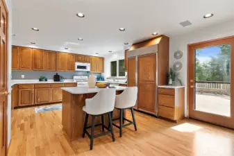 Kitchen with work island and Subzero fridge/freezer (new in 2020).  Kitchen enjoys its own access to the deck and outdoor dining area for ease of access.