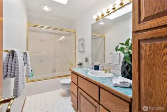 Upstairs full bathroom with tall storage cabinet