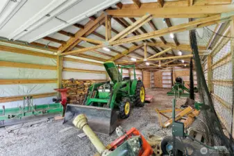 The larger outbuilding is over 60ft long and comes with the tractor and accessories!  Was used for softball practice or could park several vehicles here as well...