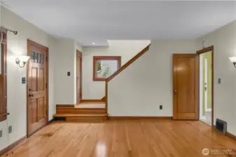 Front door; coat closet at landing of stairs to second floor.