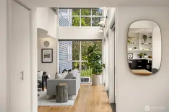 From the Entry towards Living room. Light flooding the living spaces through three sets of French Doors.