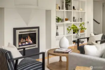 The propane fireplace is surrounded by bookshelves.
