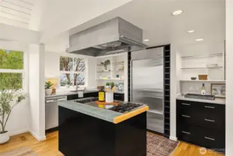 The kitchen boasts a Sub-Zero refrigerator; 48" WOLF Cook-top with griddle & grill; Stainless hood vent; Miele Dishwasher;  Wall oven; New kitchen sink,  Corian Counter-tops and tile island.