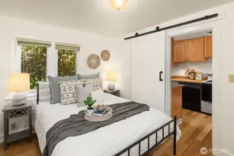 bedroom upgrades include new floors, paint and a barn door