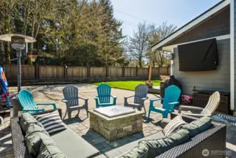 A backyard that knows how to entertain! The paver patio is already dialed in with a gas-plumbed fire pit, so you can go from zero to cozy in seconds, no firewood required. A mounted TV can stay with the home, setting the stage for outdoor movie nights or catching the game without being stuck inside. Step a little further out and you’ve got a full sport court with a basketball hoop, which is not something you come across every day. The fully fenced yard keeps everything contained and functional, while the mature trees just beyond the fence line along North Street bring in that extra layer of shade and seasonal beauty. It’s a space that makes it easy to spend more time outside, without needing to add a thing.