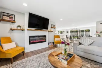 Clean white shiplap wraps the entire fireplace feature, giving it that crisp, modern farmhouse vibe without feeling overdone. The wood mantle adds warmth and contrast, while the matching built-in shelving on both sides keeps things balanced and functional for books, decor, or a little styling moment. The electric fireplace includes a blower for heat, so it’s not just for looks, it actually contributes to the comfort of the space. It’s a polished, ready-to-enjoy centerpiece that makes the whole room feel pulled together.