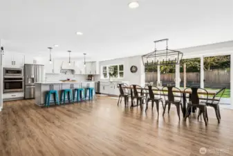 You’ve got a full dining setup for 12 that still feels comfortable, and it flows right into a beautifully open kitchen that keeps everyone connected. The oversized island adds seating for at least four more, so whether it’s casual breakfasts or guests gathering while you cook, there’s plenty of room for it all. There’s also extra storage built into the seating side of the island, which is one of those details that makes a big difference in everyday use. The cabinetry throughout features soft-close drawers and doors, adding that smooth, quiet finish that speaks to the quality of the remodel.