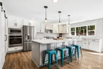 The gas range with gas oven takes center stage with a built-in griddle for everything from pancakes to late night grilled sandwiches, and the pot filler above is one of those features you don’t realize you need until you have it, then you never want to go back. The French door fridge with bottom freezer keeps things organized and easy to access, with water and ice right on the front for everyday convenience. And then there’s the bonus round, a separate electric wall oven with microwave above, giving you double the cooking power when it matters most. Holidays, gatherings, or just cooking multiple dishes at once suddenly feel a whole lot easier.