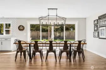 This is the kind of dining space that makes hosting feel easy. It’s expansive enough to handle a full table for 12 without feeling crowded, and the clean, modern chandelier keeps the look fresh and elevated. The large sliding glass door brings in tons of natural light and offers a full view of the backyard, but it’s the wide opening capability that really changes how the space lives. Open it up and the deck becomes an extension of the dining area, perfect for moving guests in and out or just enjoying that open-air feel. It has a relaxed, resort-like energy that makes everyday meals feel a little more special.