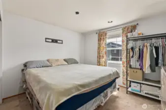 Well-sized bedroom featuring a nice window that brings in soft natural light—versatile & inviting.