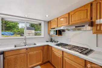Kitchen features an extra-large Wolf gas stovetop—built for serious cooking & culinary creativity!