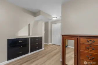 View of bedroom #2 on lower level with built-in drawers/storage.