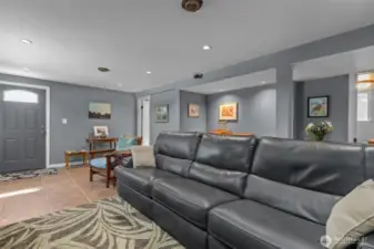 View of rec room on lower level. Basement door leads to shop and driveway.