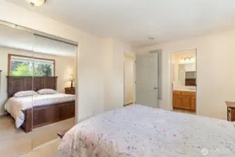 Another view of the primary with mirrored closet doors.
