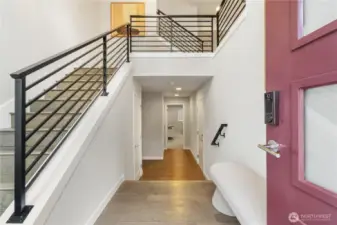 Soaring ceilings, walls of windows, and upscale finishes set the tone with hardwood floors, modern metal railings