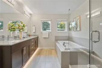 Primary bathroom with shower and bathtub.