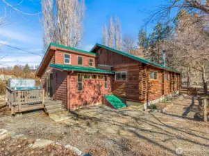 Exterior – Daylight  Charming log home with metal roof and inviting deck, blending rustic character with modern updates — private, peaceful, and just minutes from Lake Chelan recreation.