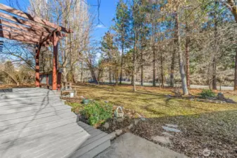 Pergola & Deck Area -  Charming pergola and expansive deck create the perfect setting for outdoor dining, entertaining, or relaxing under the trees.