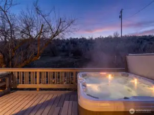 Hot Tub at Dusk -  Soak beneath colorful Chelan sunsets in your private hot tub retreat just off the primary suite.