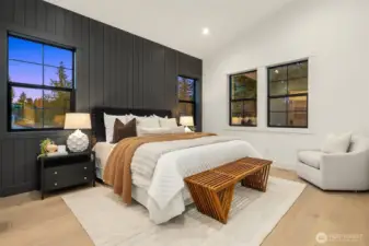Primary bedroom with vaulted ceiling and stunning accent wall