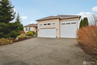 Oversized driveway, 3-car garage including RV bay, offering exceptional parking and storage