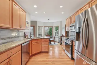 Kitchen with granite countertops and newer stainless steel appliances.