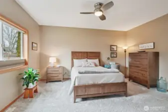 Spacious primary suite with new carpet.