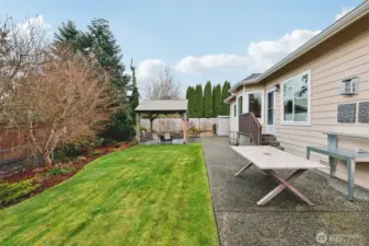 Private backyard with landscaped lawn.