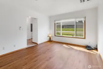 Bright living room, with ceiling flush mounted mini-split for heat and A/C.