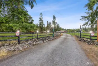 The paved driveway is gated with an electric gate and keypad. The property is well lit, for function and fun!