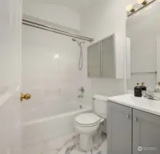 Full bathroom situated between two bedrooms on third floor