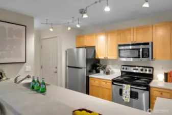 Stainless-steel appliances complement warm wood cabinets.