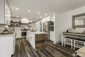 Expansive kitchen offers a flexible bump-out area designed for work, homework, or hobbies.
